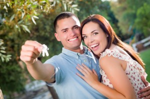 Happy Excited Mixed Race Couple with New House Keys Outside.